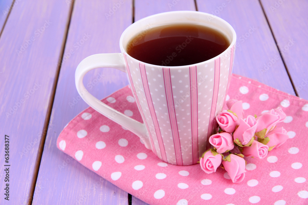 Fragrant tea with flowers on wooden table close-up