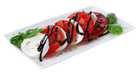 Caprese salad with mozarella cheese, tomatoes and basil