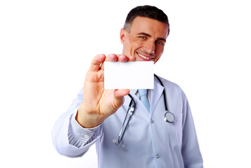 Happy male doctor holding blank card