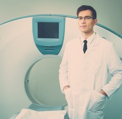 Wall Mural - Young doctor standing near computed tomography scanner 