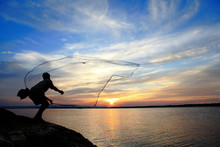 Fisherman Casting His Net At Sunrise