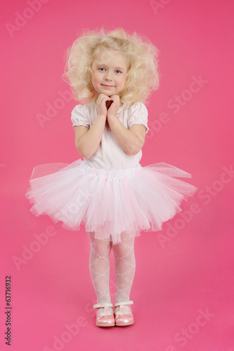 Fotografie, Obraz Little girl in a tutu skirt on pink background