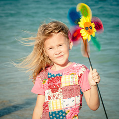 Adorable happy smiling girl on beach vacation