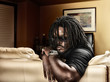 cool black man with dreads on leather couch.