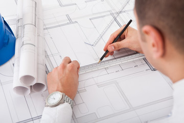 Architect Working On Blueprint Design