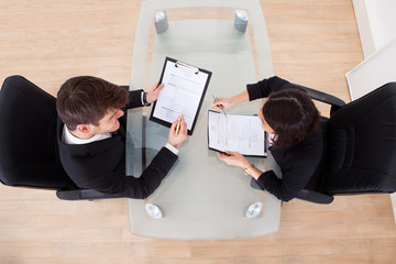 Poster - Business People Discussing Over Documents