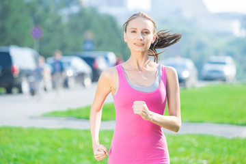 Jogging woman running in city park