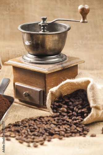 Naklejka na szybę still life of coffee beans in jute bag with coffee grinder