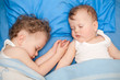 © golovianko - Adorable little brothers sleeping together in bed