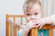 © golovianko - Cute toddler looking out of the crib
