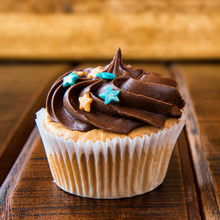Sweet Chocolate Cupcake On Wooden Background