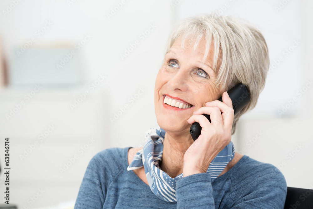 lächelnde rentnerin am telefon
