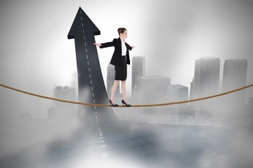 Poster - Composite image of businesswoman performing a balancing act
