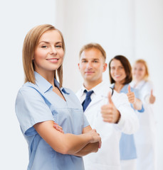 Wall Mural - smiling female doctor or nurse