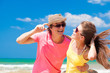 © el.rudakova - Portrait of happy young couple in sunglasses smiling on beach