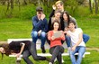 © iVangelos - Group of young adults browsing a tablet outside