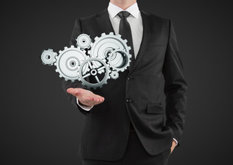 Canvas Print - businessman holding gears