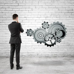 Poster - businessman looking at  gears