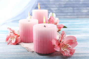 Poster - Beautiful candles with flowers on wooden background