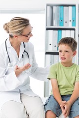 Wall Mural - Doctor talking with boy in clinic