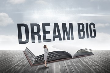 Poster - Dream big against open book against sky