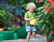 © endostock - White little barefoot girl playing with water can
