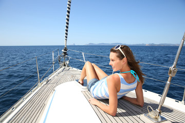 Wall Mural - Woman relaxing on sailboat deck