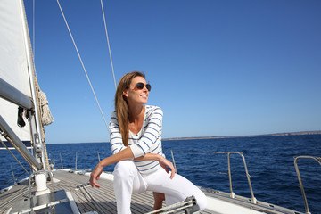 Wall Mural - Attractive modern woman enjoying sailing cruise