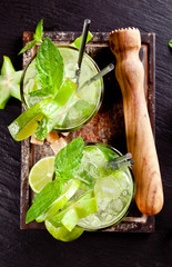 Fototapete - Fresh mojito drinks on stone surface