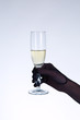Female hand in black opera glove holding champagne glass