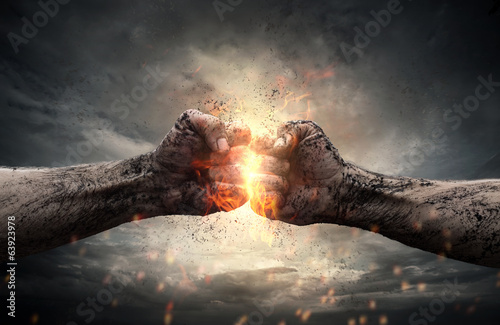 Photographie Combattez, deux poings se frappant sur le ciel dramatique
