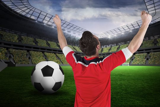 Composite image of excited football fan cheering