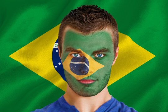 Composite image of serious young brasil fan with facepaint