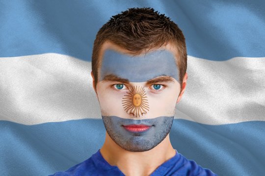 Composite image of serious young argentina fan with facepaint