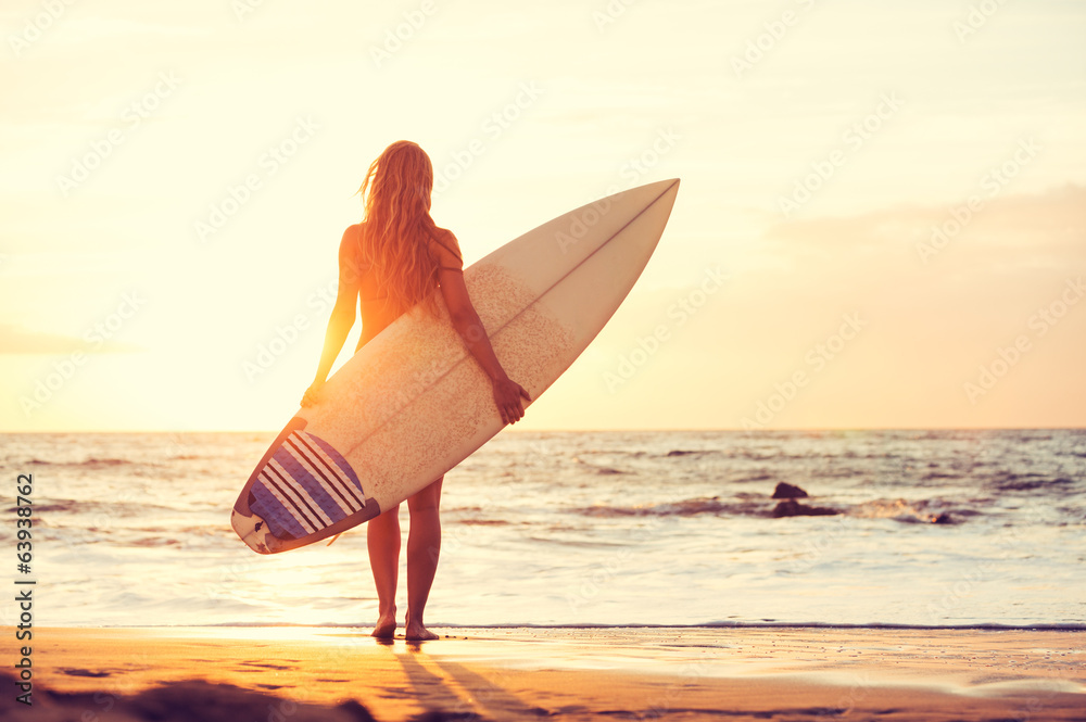 Surfer girl on the beach at sunset Stock Photo | Adobe Stock