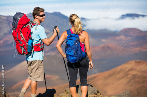 Fotografie, Obraz Hikers enjoying the view from the mountain top