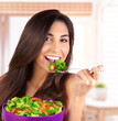 Beautiful woman eating salad