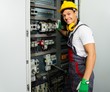© Nejron Photo - Cheerful electrician in a safety hat on a factory