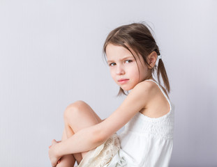 portrait of angry preschooler girl in closed pose