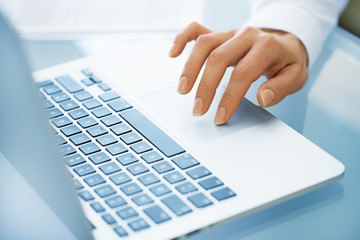 Close-up of hand woman using a laptop computer