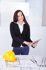 Poster - Architect With Digital Tablet Standing At Desk
