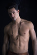 © theartofphoto - Athletic shirtless young man with mustache smoking