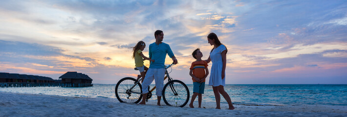 Wall Mural - family with a bike at tropical beach