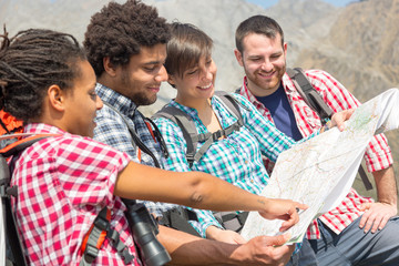 Wall Mural - Hikers Looking at Map on top of Mountain