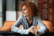 © Xalanx - Redhead lady sitting at table