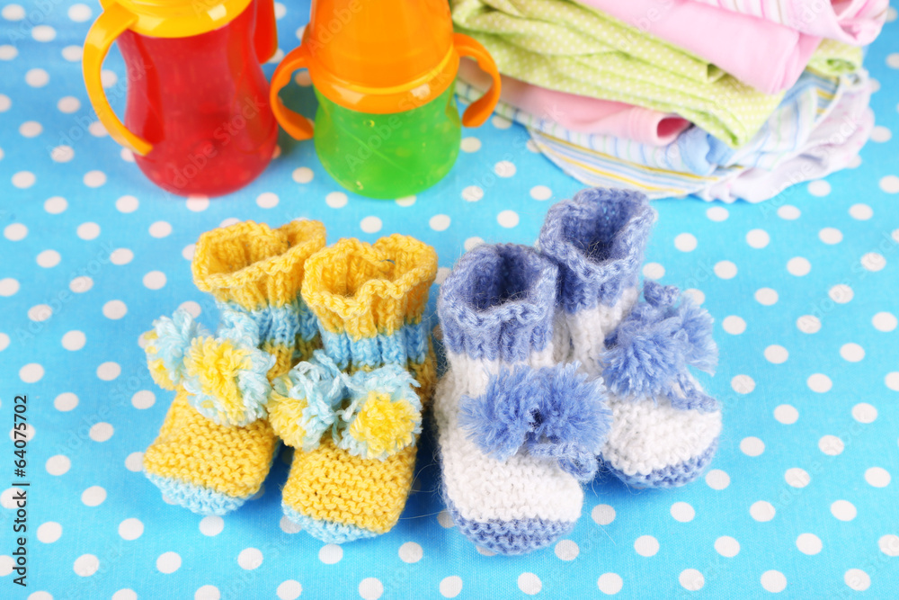 Composition with crocheted booties for baby, clothes and other