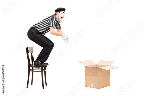 Fotografie, Obraz Mime artist jumping in an empty box