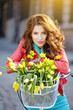 © ZoomTeam - sensual brunette girl sitting on bicycle with some spring flower