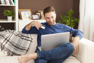 Poster - Smiling man during online shopping at home