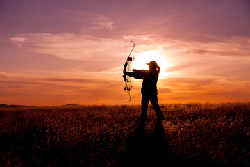 Woman Bowhunter in Sunset